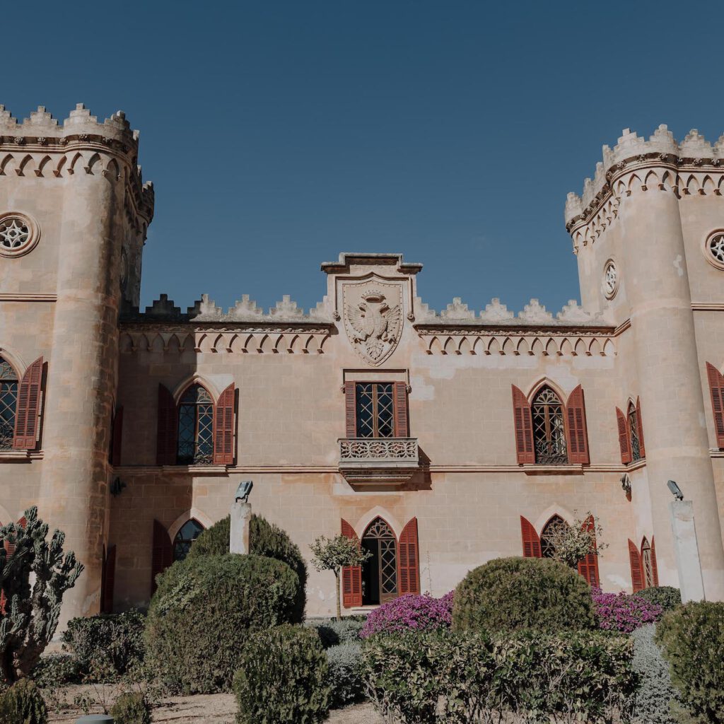 Outdoor wedding setup at a fairytale castle venue in Mallorca, surrounded by lush gardens