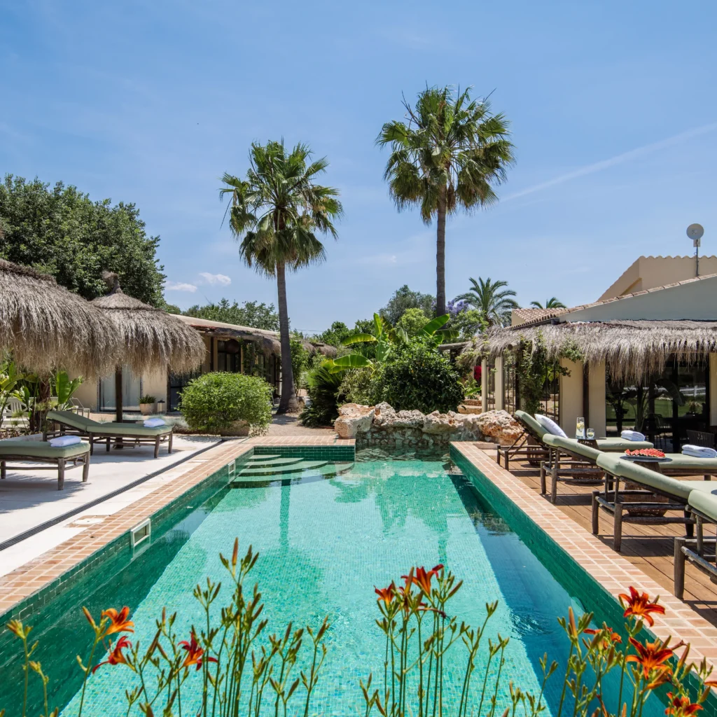 Luxury villa with a tropical pool area in Mallorca, perfect for relaxation and events.