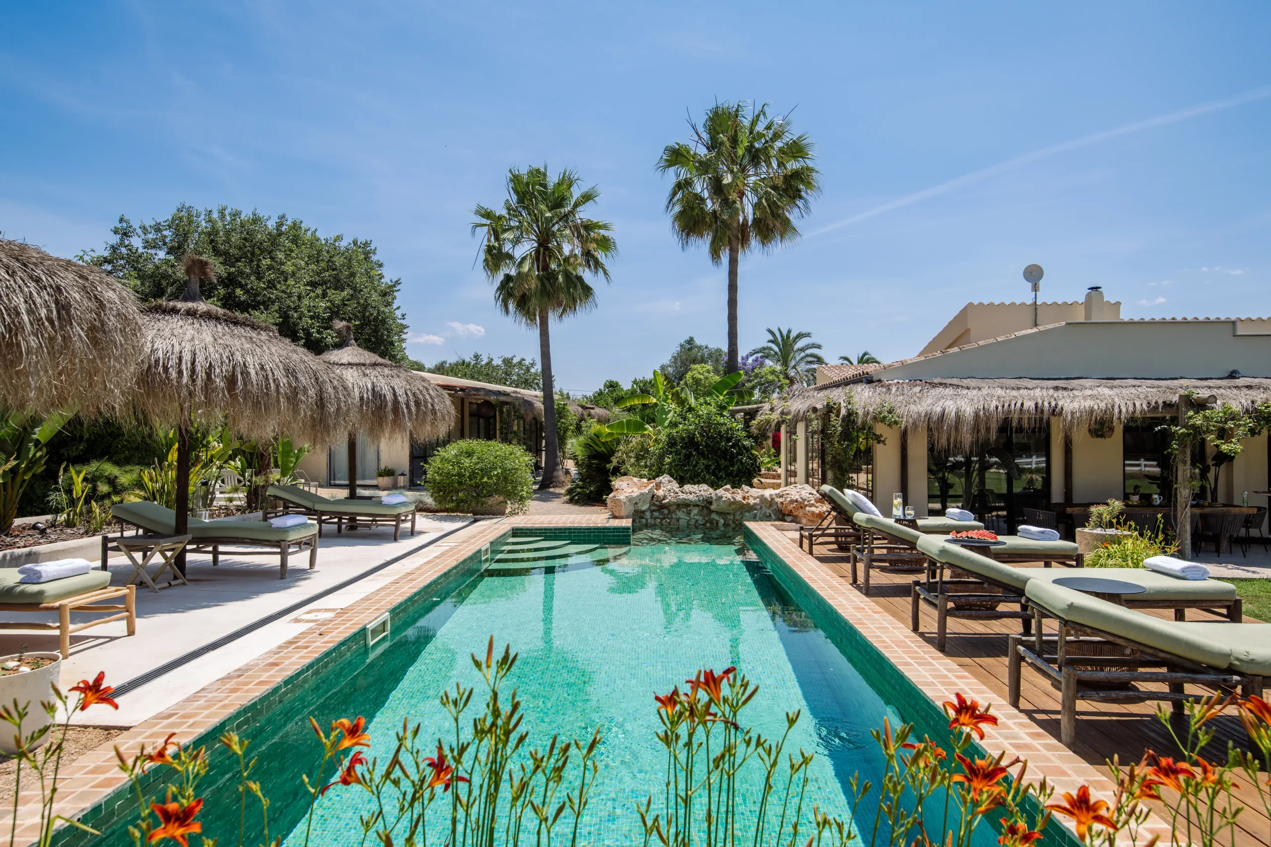 Luxury villa with a tropical pool area in Mallorca, perfect for relaxation and events.